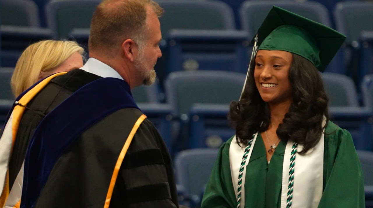 A PCHS student smiles as she receives her diploma.